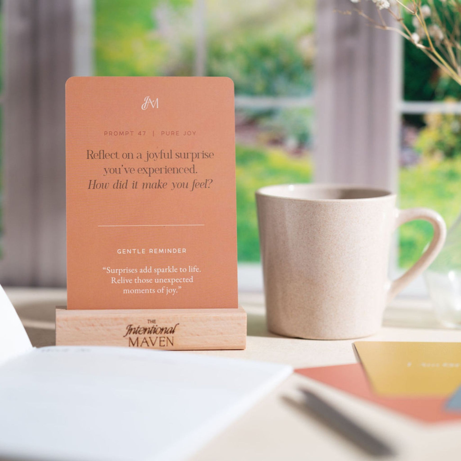 Close-up of the prompt card stock, and solid wood stand with the journal in the foreground.