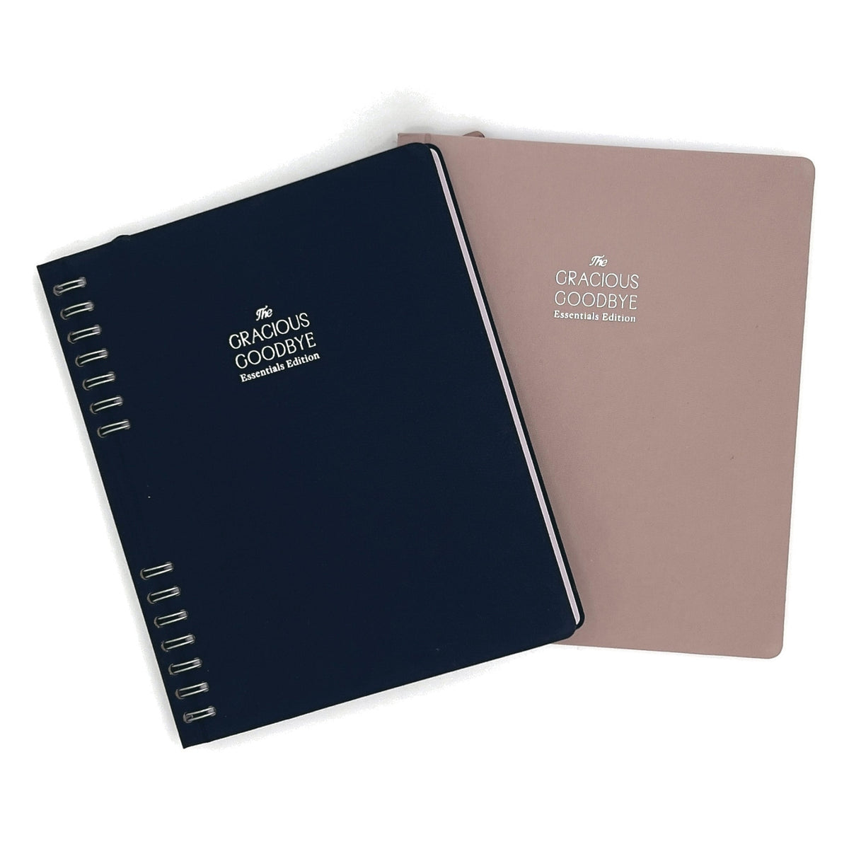 The Gracious Goodbye Essentials in both editions, navy stacked on Stone, showing the compact B5 footprint.