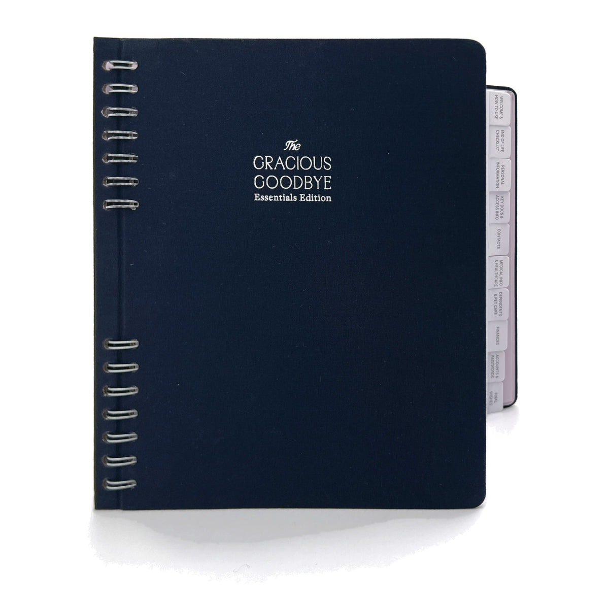 The Gracious Goodbye Essentials planner in navy linen, closed, with its silver-foil title and half-hidden spiral.