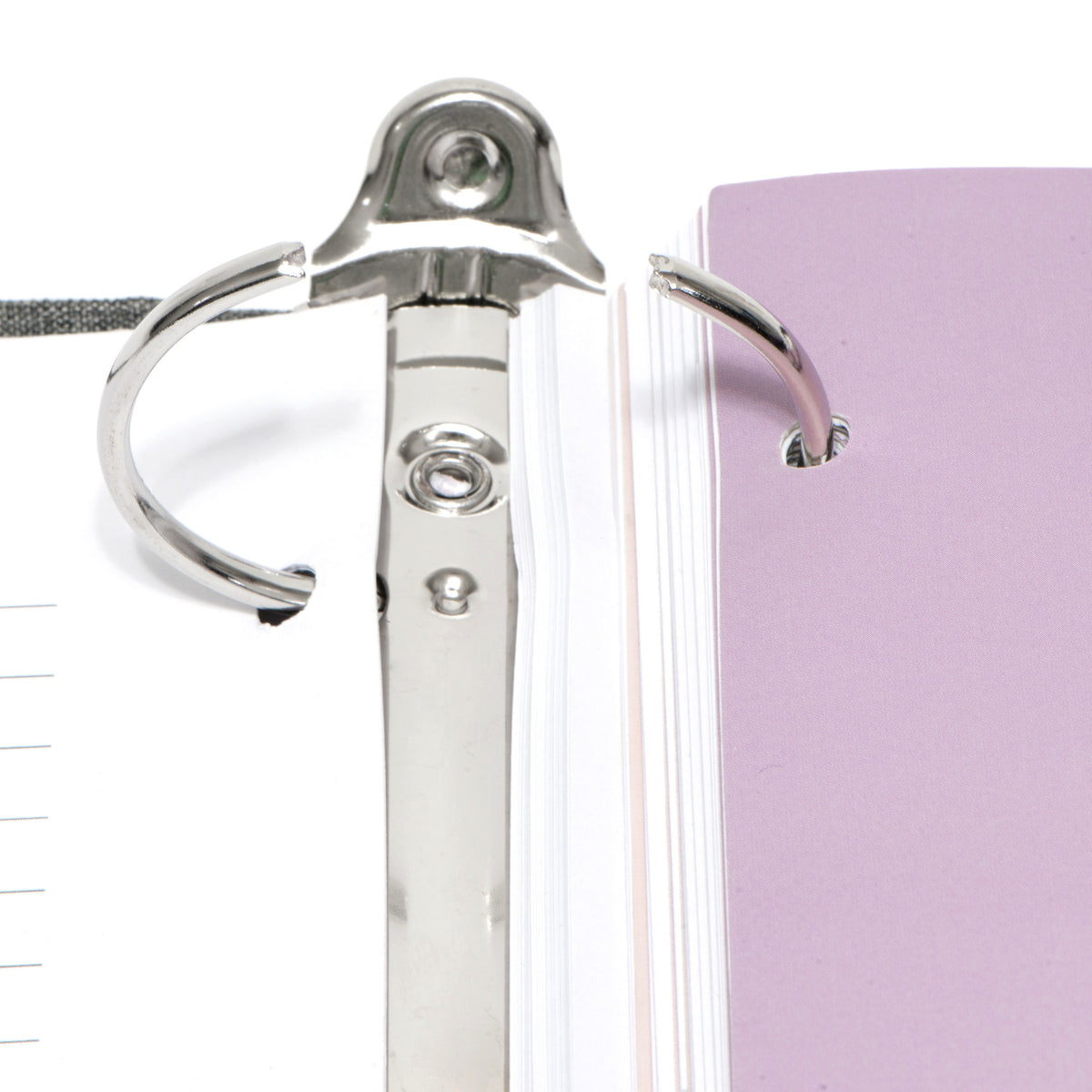 Close-up of the three-ring mechanism inside The Gracious Goodbye planner, which opens so pages can be added or replaced.